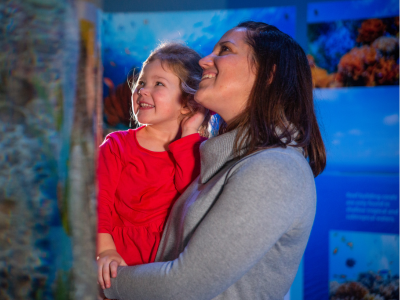 Girl and Mom looking at exhibit